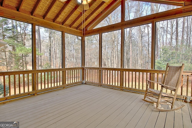 unfurnished sunroom featuring lofted ceiling with beams, wooden ceiling, and ceiling fan