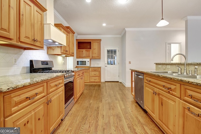 kitchen with pendant lighting, backsplash, appliances with stainless steel finishes, a sink, and light stone countertops