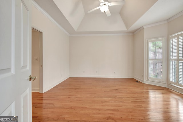 empty room featuring ornamental molding, light wood-type flooring, and a ceiling fan