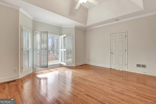 unfurnished room with light wood-style floors, visible vents, and crown molding