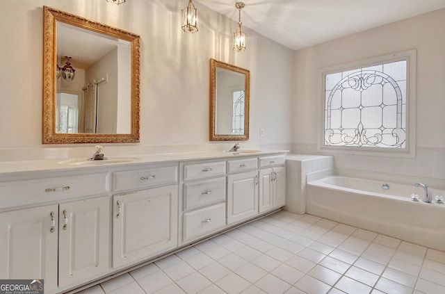 bathroom featuring tile patterned flooring, a sink, a bath, and double vanity