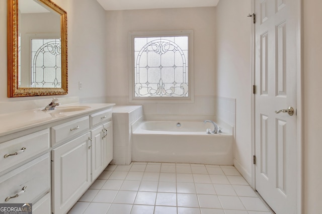 bathroom featuring tile patterned floors, a bath, and vanity