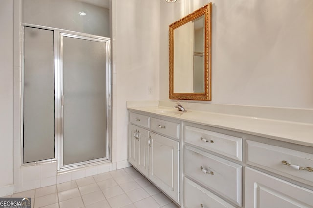 full bath with a stall shower, tile patterned flooring, and vanity