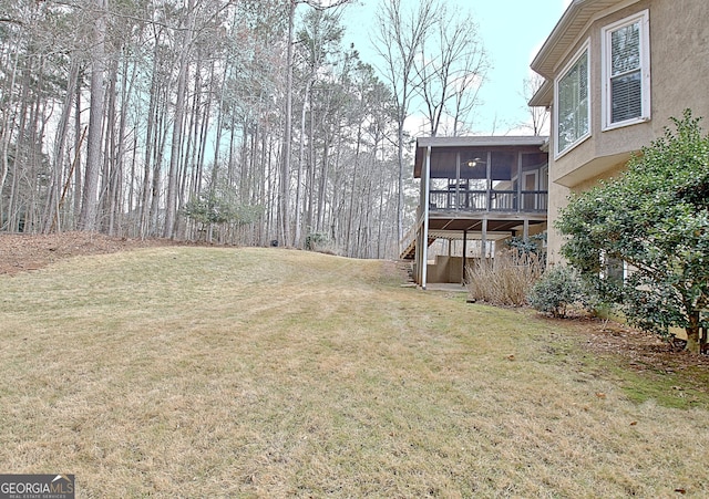 view of yard with a sunroom and stairs