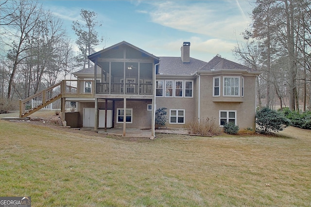 back of property with a sunroom, a chimney, stairs, a yard, and a patio area