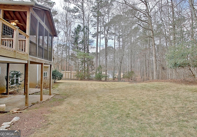 view of yard with a sunroom and fence