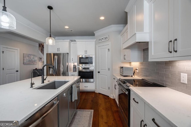 kitchen featuring appliances with stainless steel finishes, white cabinetry, and pendant lighting