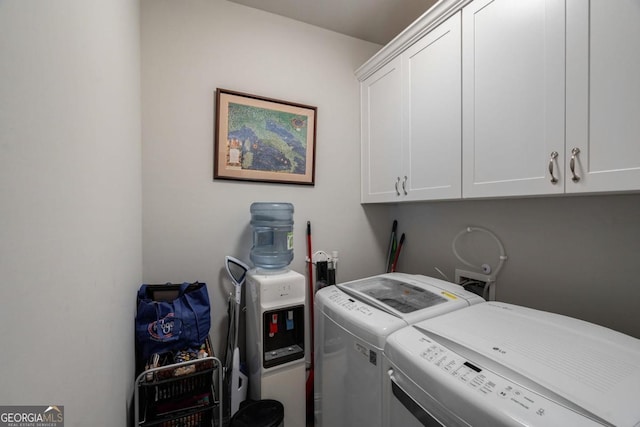 laundry room with cabinet space and washer and clothes dryer