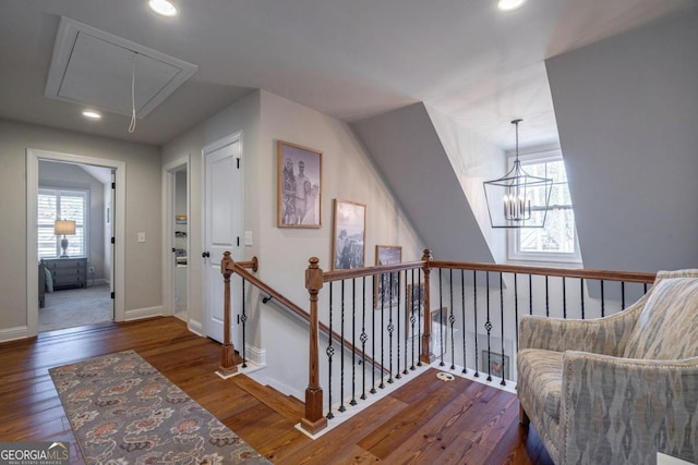 sitting room with attic access, baseboards, dark wood finished floors, an upstairs landing, and recessed lighting