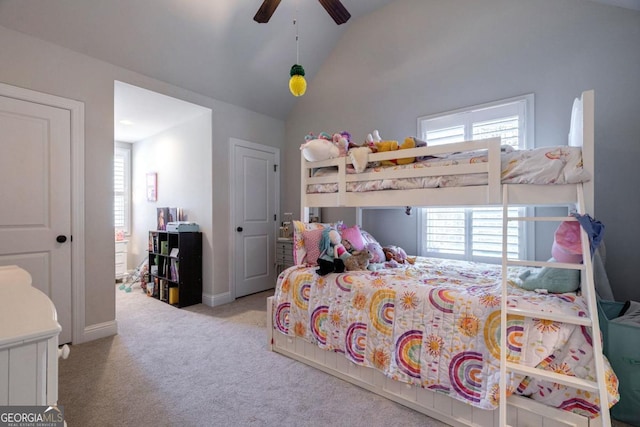 bedroom featuring lofted ceiling, light carpet, ceiling fan, and multiple windows