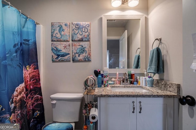 bathroom featuring toilet and vanity