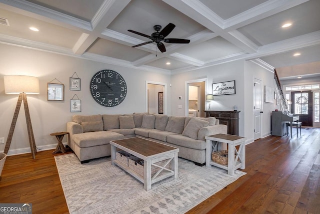 living room with baseboards, coffered ceiling, wood finished floors, and beamed ceiling