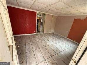 unfurnished room featuring tile patterned flooring and a paneled ceiling