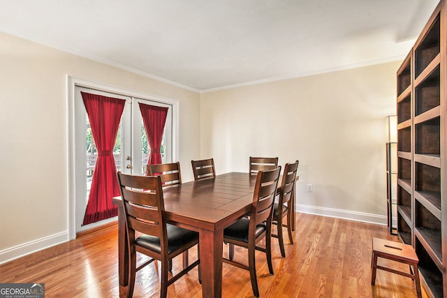 dining space with crown molding, french doors, light wood-style flooring, and baseboards