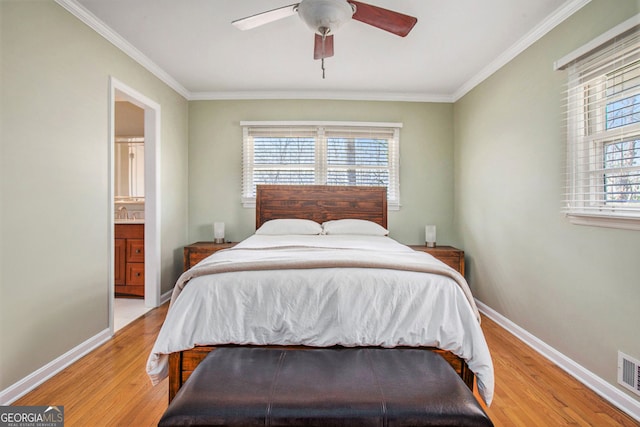 bedroom featuring multiple windows, light wood-style flooring, and baseboards