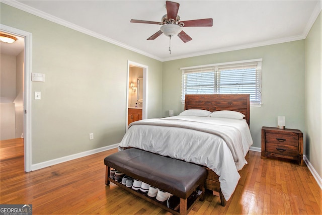 bedroom with ceiling fan, connected bathroom, light wood-style flooring, baseboards, and crown molding