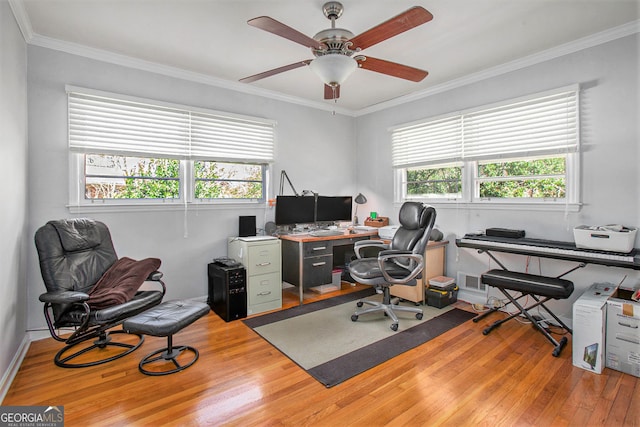 home office with plenty of natural light, crown molding, and wood finished floors