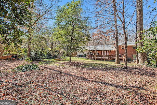 view of yard featuring a wooden deck