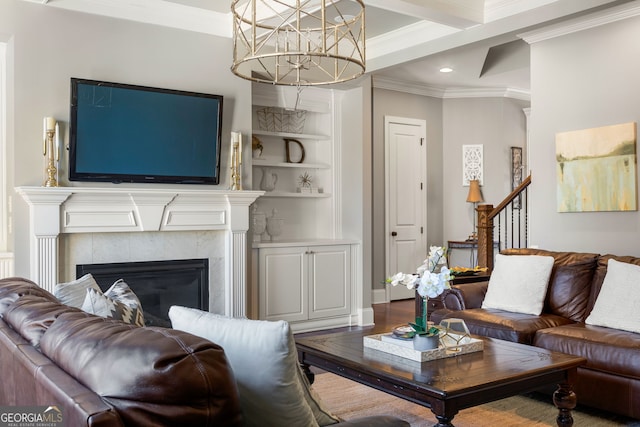 living area featuring built in shelves, a fireplace, crown molding, recessed lighting, and wood finished floors