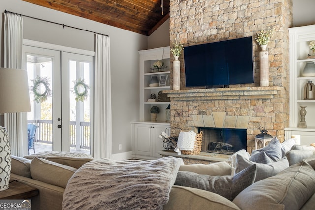 living area with lofted ceiling, a stone fireplace, french doors, and wooden ceiling