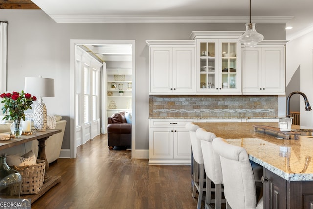 kitchen with dark wood-type flooring, white cabinets, and glass insert cabinets