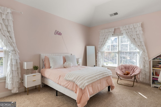 bedroom featuring lofted ceiling, baseboards, visible vents, and carpet flooring