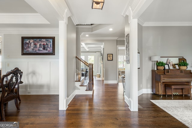 foyer featuring recessed lighting, a decorative wall, wood finished floors, ornamental molding, and stairway