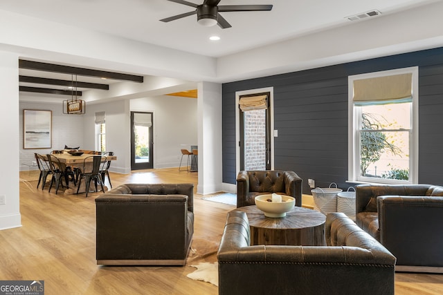 living room with baseboards and light wood-style floors