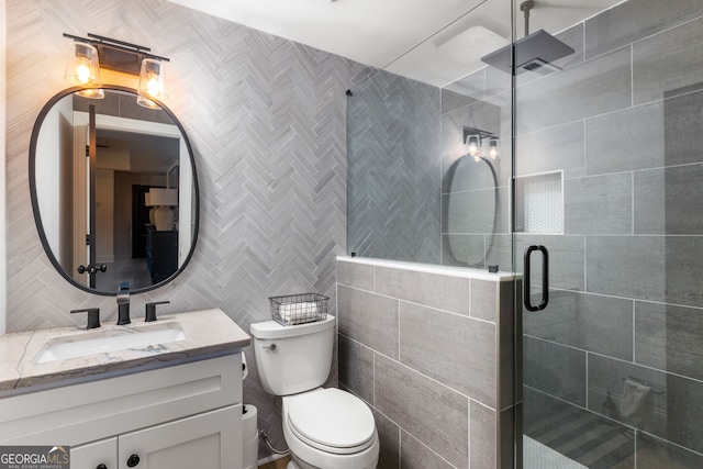 full bath featuring tile walls, backsplash, toilet, a shower stall, and vanity