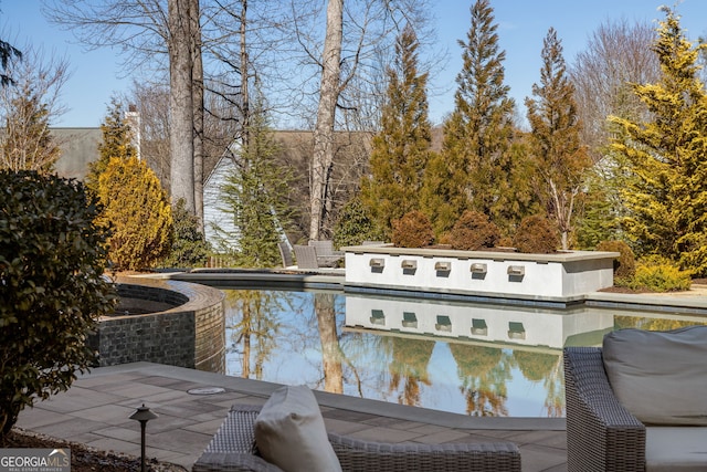 view of pool with a pool with connected hot tub