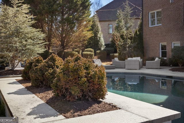 outdoor pool featuring a patio and an outdoor hangout area