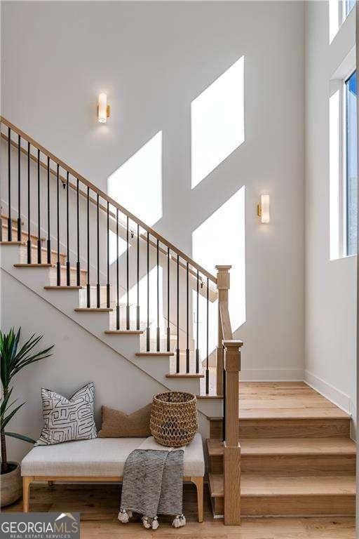 1273 Danner St SE, Atlanta, GA 30316 - stairway with healthy amount of natural light, wood finished floors, a high ceiling, and baseboards
