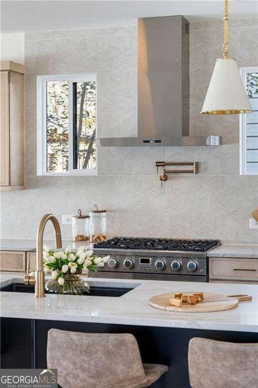 1273 Danner St SE, Atlanta, GA 30316 - kitchen featuring backsplash, wall chimney range hood, healthy amount of natural light, and a sink
