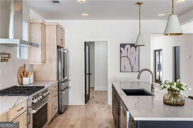 1273 Danner St SE, Atlanta, GA 30316 - kitchen featuring wall chimney range hood, high quality appliances, a sink, an island with sink, and light wood-type flooring