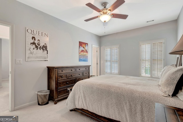 bedroom featuring light colored carpet, visible vents, ceiling fan, and baseboards