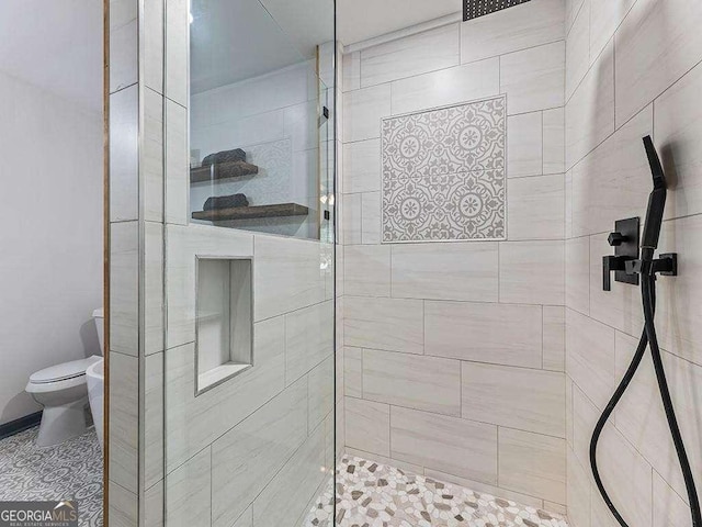 bathroom with a shower stall and toilet