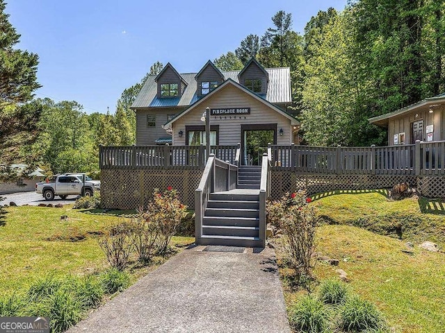 view of front of house featuring a front lawn, stairway, and a deck