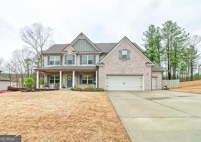 craftsman-style house with a porch, board and batten siding, fence, a garage, and driveway