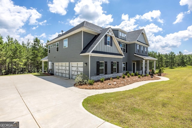 view of front of property with a garage, driveway, roof with shingles, a front lawn, and board and batten siding