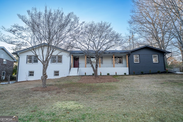 single story home with covered porch, a front yard, and brick siding