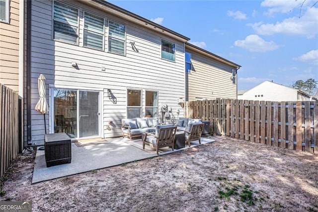 back of property with a fenced backyard, a patio, and an outdoor hangout area