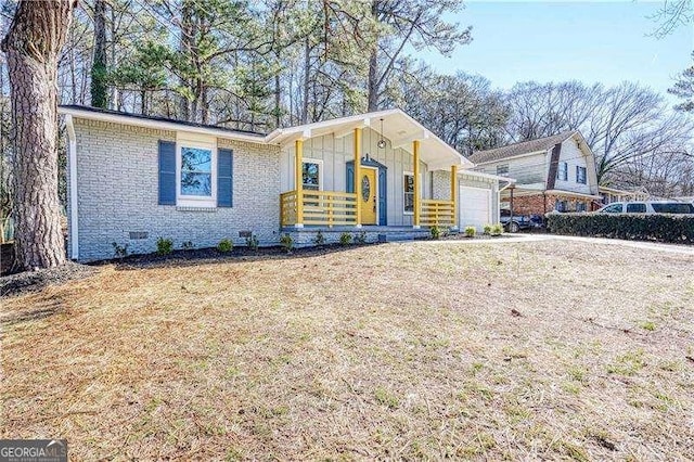 view of front of property featuring board and batten siding, crawl space, brick siding, and an attached garage