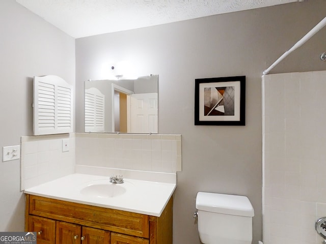 full bath featuring vanity and toilet