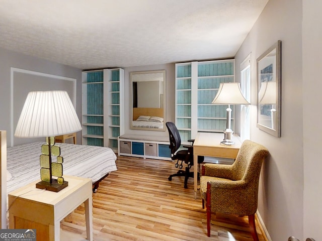 interior space with a textured ceiling and wood finished floors