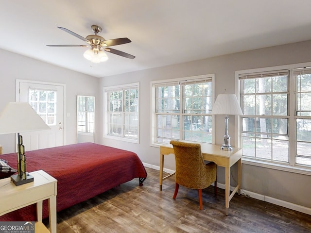 bedroom featuring a ceiling fan, baseboards, and wood finished floors