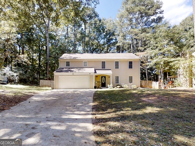 view of front of property with concrete driveway, fence, and an attached garage