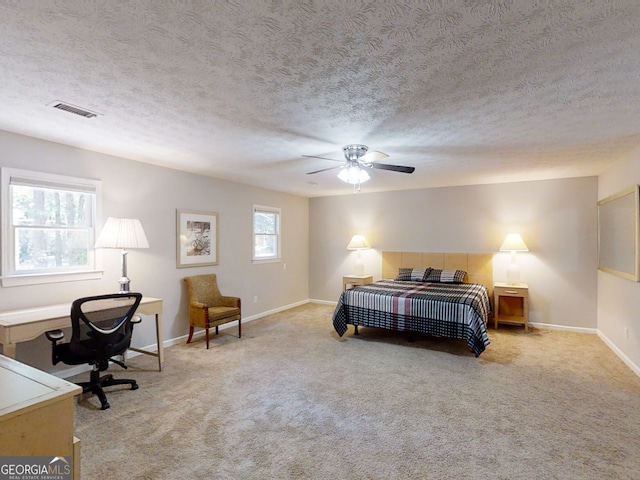 bedroom with baseboards, visible vents, and light colored carpet