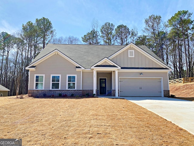 craftsman inspired home featuring a garage, brick siding, board and batten siding, and concrete driveway