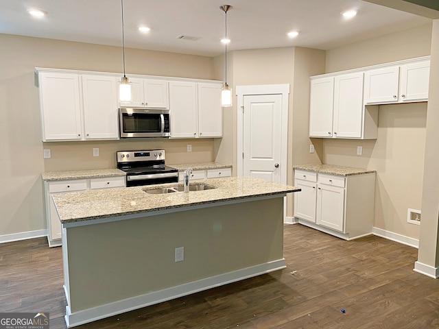 101 Westminster Ct, Winder, GA 30680 - kitchen with stainless steel appliances, white cabinets, an island with sink, dark wood finished floors, and recessed lighting