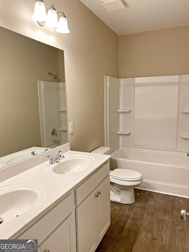 101 Westminster Ct, Winder, GA 30680 - full bathroom with double vanity, wood finished floors, and bathtub / shower combination